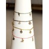 Bracelet tissé avec des petits pendentifs dorés croix, papillon, trèfles